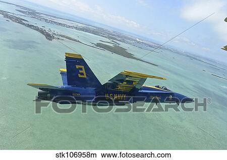 An F/A-18 Hornet of the Blue Angels flies over the Florida Keys. View Large Photo Image Picture - An F/A-18 Hornet of the Blue Angels flies over the Florida Keys.. Fotosearch