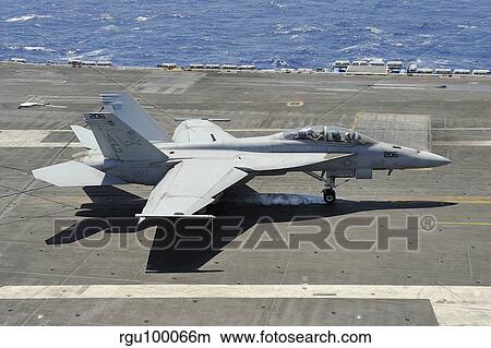 An F/A-18 Hornet of the U. S. Navy landing aboard USS Eisenhower. View Large Photo Image Picture - An F/A-18 Hornet of the U. S. Navy landing aboard USS Eisenhower.. Fotosearch