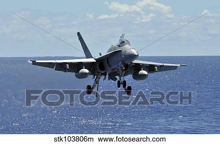 An F/A-18C Hornet approaches the flight deck of the aircraft carrier USS Ronald Reagan. View Large Photo Image Picture - An F/A-18C Hornet approaches the flight deck of the aircraft carrier USS Ronald Reagan.. Fotosearch