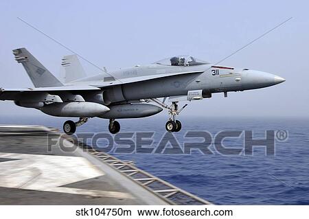 An F/A-18C Hornet catapults from the aircraft carrier USS Ronald Reagan. View Large Photo Image Picture - An F/A-18C Hornet catapults from the aircraft carrier USS Ronald Reagan.. Fotosearch