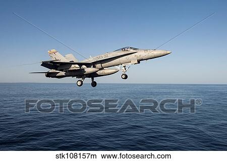 An F/A-18C Hornet flies above the Gulf of Oman. View Large Photo Image Picture - An F/A-18C Hornet flies above the Gulf of Oman.. Fotosearch