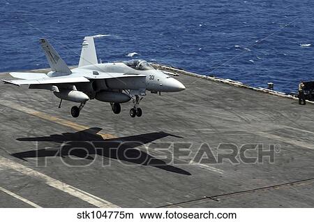 An F/A-18C Hornet lands aboard the aircraft carrier USS Ronald Reagan. View Large Photo Image Picture - An F/A-18C Hornet lands aboard the aircraft carrier USS Ronald Reagan.. Fotosearch