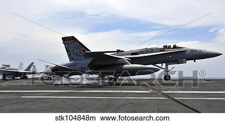 An F/A-18C Hornet lands aboard the Nimitz-class aircraft carrier USS John C. Stennis. View Large Photo Image Picture - An F/A-18C Hornet lands aboard the Nimitz-class aircraft carrier USS John C. Stennis.. Fotosearch
