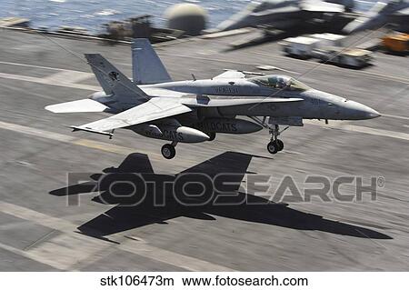 An F/A-18C Hornet lands aboard USS Dwight D. Eisenhower. View Large Photo Image Picture - An F/A-18C Hornet lands aboard USS Dwight D. Eisenhower.. Fotosearch