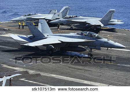 An F/A-18C Hornet lands on the flight deck of USS George H. W. Bush. View Large Photo Image Picture - An F/A-18C Hornet lands on the flight deck of USS George H. W. Bush.. Fotosearch