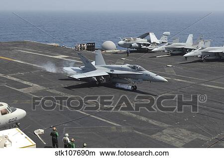 An F/A-18C Hornet lands on the flight deck of USS Nimitz. View Large Photo Image Picture - An F/A-18C Hornet lands on the flight deck of USS Nimitz.. Fotosearch