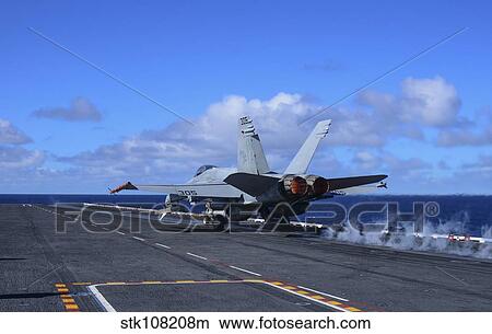 An F/A-18C Hornet launches from aircraft carrier USS Carl Vinson. View Large Photo Image Picture - An F/A-18C Hornet launches from aircraft carrier USS Carl Vinson.. Fotosearch