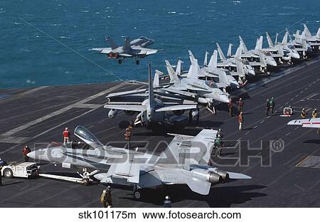 An F/A-18C Hornet launches from the flight deck aboard USS Theodore Roosevelt. View Large Photo Image Picture - An F/A-18C Hornet launches from the flight deck aboard USS Theodore Roosevelt.. Fotosearch