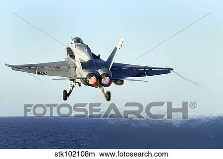 An F/A-18C Hornet launches from the flight deck of USS John C. Stennis. View Large Photo Image Picture - An F/A-18C Hornet launches from the flight deck of USS John C. Stennis.. Fotosearch