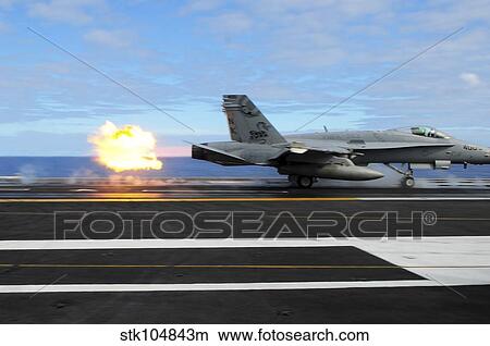 An F/A-18C Hornet launches from the aircraft carrier USS Ronald Reagan. View Large Photo Image Picture - An F/A-18C Hornet launches from the aircraft carrier USS Ronald Reagan.. Fotosearch