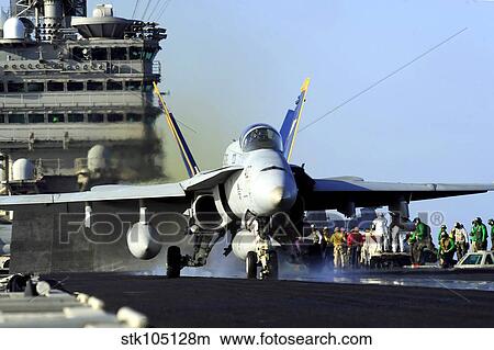 An F/A-18C Hornet launches from the aircraft carrier USS John C. Stennis. View Large Photo Image Picture - An F/A-18C Hornet launches from the aircraft carrier USS John C. Stennis.. Fotosearch