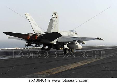 An F/A-18C Hornet launches from the flight deck of USS Abraham Lincoln. View Large Photo Image Picture - An F/A-18C Hornet launches from the flight deck of USS Abraham Lincoln.. Fotosearch