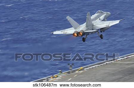 An F/A-18C Hornet launches from the flight deck of USS Nimitz. View Large Photo Image Picture - An F/A-18C Hornet launches from the flight deck of USS Nimitz.. Fotosearch