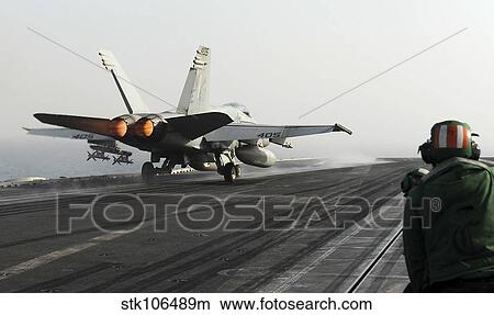 An F/A-18C Hornet launches from the flight deck of USS Abraham Lincoln. View Large Photo Image Picture - An F/A-18C Hornet launches from the flight deck of USS Abraham Lincoln.. Fotosearch