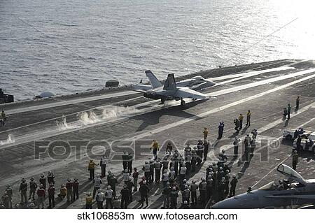 An F/A-18C Hornet launches from the flight deck of USS Dwight D. Eisenhower. View Large Photo Image Picture - An F/A-18C Hornet launches from the flight deck of USS Dwight D. Eisenhower.. Fotosearch