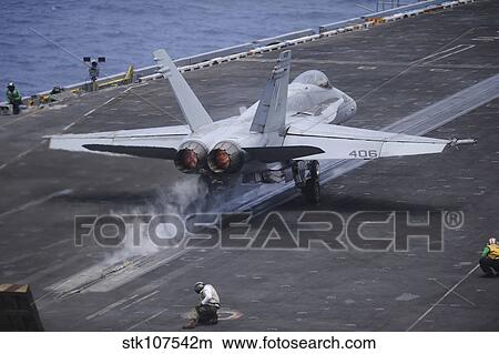 An F/A-18C Hornet launches from the aircraft carrier USS Nimitz. View Large Photo Image Picture - An F/A-18C Hornet launches from the aircraft carrier USS Nimitz.. Fotosearch