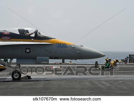 An F/A-18C Hornet launches from the flight deck of USS Nimitz. View Large Photo Image Picture - An F/A-18C Hornet launches from the flight deck of USS Nimitz.. Fotosearch
