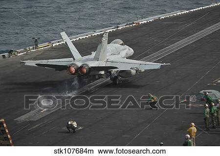 An F/A-18C Hornet launches from the flight deck aboard USS Nimitz. View Large Photo Image Picture - An F/A-18C Hornet launches from the flight deck aboard USS Nimitz.. Fotosearch