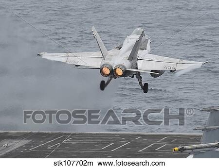 An F/A-18C Hornet launches from the flight deck of USS Nimitz. View Large Photo Image Picture - An F/A-18C Hornet launches from the flight deck of USS Nimitz.. Fotosearch