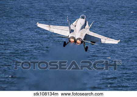 An F/A-18C Hornet launches from the flight deck of USS Harry S. Truman. View Large Photo Image Picture - An F/A-18C Hornet launches from the flight deck of USS Harry S. Truman.. Fotosearch