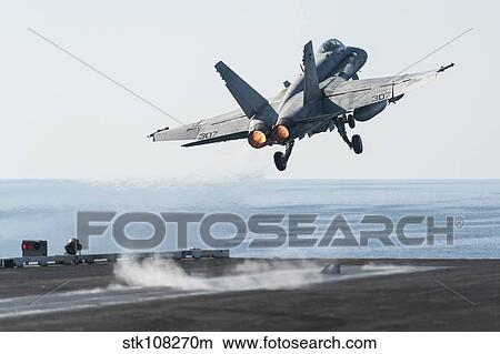 An F/A-18C Hornet launches from the flight deck of USS Harry S. Truman. View Large Photo Image Picture - An F/A-18C Hornet launches from the flight deck of USS Harry S. Truman.. Fotosearch