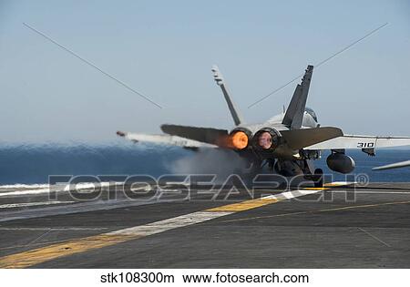 An F/A-18C Hornet launches from the flight deck of USS Carl Vinson. View Large Photo Image Picture - An F/A-18C Hornet launches from the flight deck of USS Carl Vinson.. Fotosearch