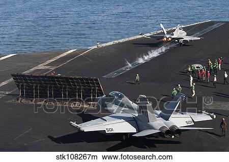 An F/A-18C Hornet launches from the the flight deck of USS Harry S. Truman. View Large Photo Image Picture - An F/A-18C Hornet launches from the the flight deck of USS Harry S. Truman.. Fotosearch