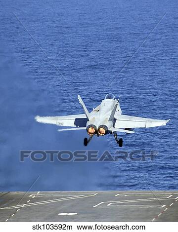 An F/A-18C Hornet launches from the USS Abraham Lincoln. View Large Photo Image Picture - An F/A-18C Hornet launches from the USS Abraham Lincoln.. Fotosearch
