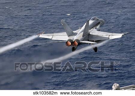 An F/A-18C Hornet launches off the flight deck of USS John C. Stennis. View Large Photo Image Picture - An F/A-18C Hornet launches off the flight deck of USS John C. Stennis.. Fotosearch