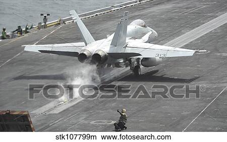 An F/A-18C Hornet launches off the flight deck of USS Nimitz. View Large Photo Image Picture - An F/A-18C Hornet launches off the flight deck of USS Nimitz.. Fotosearch