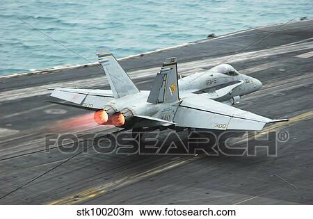 An F/A-18C Hornet makes an arrested landing on the aircraft carrier USS Theodore Roosevelt. View Large Photo Image Picture - An F/A-18C Hornet makes an arrested landing on the aircraft carrier USS Theodore Roosevelt.. Fotosearch