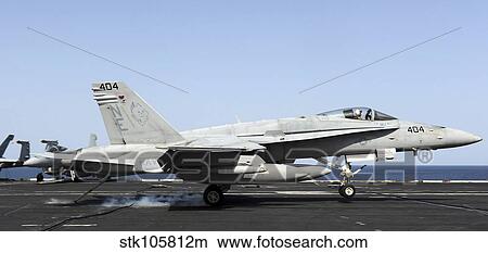 An F/A-18C Hornet makes an arrested landing on USS Abraham Lincoln. View Large Photo Image Picture - An F/A-18C Hornet makes an arrested landing on USS Abraham Lincoln.. Fotosearch