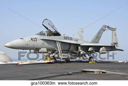 An F/A-18C Hornet on the flight deck of USS Theodore Roosevelt. View Large Photo Image Picture - An F/A-18C Hornet on the flight deck of USS Theodore Roosevelt.. Fotosearch