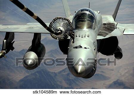 An F/A-18C Hornet receives fuel from the drogue of a KC-10 Extender. View Large Photo Image Picture - An F/A-18C Hornet receives fuel from the drogue of a KC-10 Extender.. Fotosearch