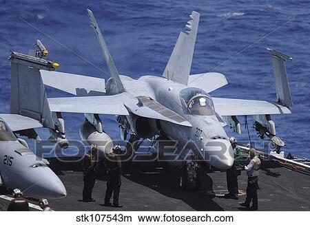 An F/A-18C Hornet sits ready for take off from the flight deck of USS Nimitz. View Large Photo Image Picture - An F/A-18C Hornet sits ready for take off from the flight deck of USS Nimitz.. Fotosearch