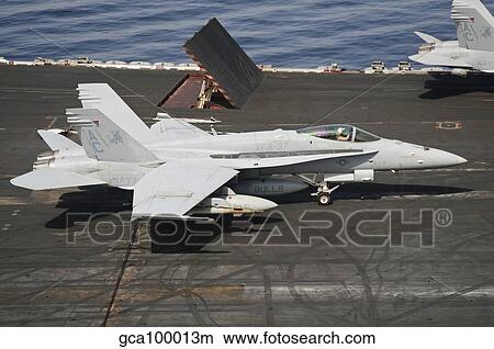 An F/A-18C Hornet sits ready on the flight deck of USS Harry S. Truman. View Large Photo Image Picture - An F/A-18C Hornet sits ready on the flight deck of USS Harry S. Truman.. Fotosearch