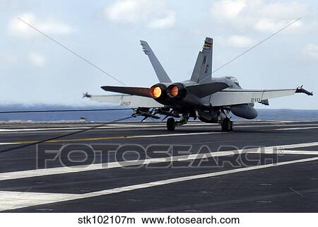 An F/A-18C Hornet successfully lands on the flight deck of USS John C. Stennis. View Large Photo Image Picture - An F/A-18C Hornet successfully lands on the flight deck of USS John C. Stennis.. Fotosearch
