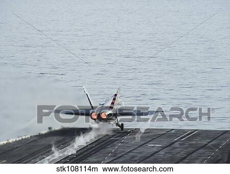 An F/A-18C Hornet takes off from the flight deck of USS Theodore Roosevelt. View Large Photo Image Picture - An F/A-18C Hornet takes off from the flight deck of USS Theodore Roosevelt.. Fotosearch