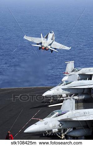 An F/A-18C Hornet takes off from the flight deck of USS George H. W. Bush. View Large Photo Image Picture - An F/A-18C Hornet takes off from the flight deck of USS George H. W. Bush.. Fotosearch