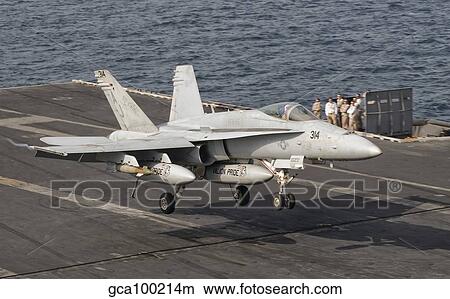 An F/A-18C Hornet trap landing aboard USS George H. W. Bush. View Large Photo Image Picture - An F/A-18C Hornet trap landing aboard USS George H. W. Bush.. Fotosearch