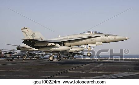 An F/A-18C Hornet trap landing aboard USS George H. W. Bush. View Large Photo Image Picture - An F/A-18C Hornet trap landing aboard USS George H. W. Bush.. Fotosearch