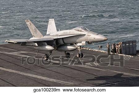 An F/A-18C Hornet trap landing aboard USS George H. W. Bush. View Large Photo Image Picture - An F/A-18C Hornet trap landing aboard USS George H. W. Bush.. Fotosearch
