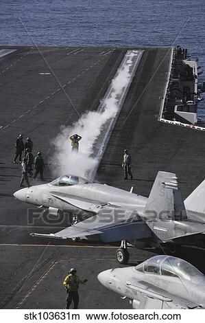 An FA-18D Hornet taxis to the catapult aboard the aircraft carrier USS Ronald Reagan. View Large Photo Image Picture - An FA-18D Hornet taxis to the catapult aboard the aircraft carrier USS Ronald Reagan.. Fotosearch
