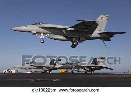 An F/A-18E Super Hornet comes in for an arrested landing. View Large Photo Image Picture - An F/A-18E Super Hornet comes in for an arrested landing.. Fotosearch