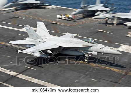 Picture - An F/A-18E Super Hornet hooks an arresting gear wire while landing.. Fotosearch
