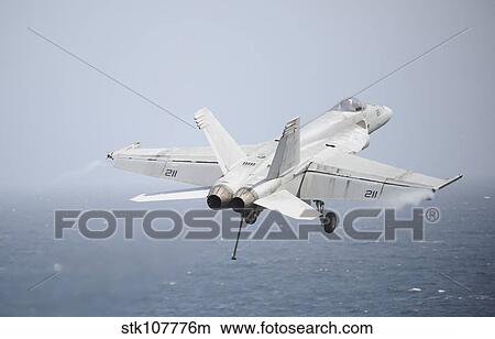 An F/A-18E Super Hornet in flight over the Gulf of Oman. View Large Photo Image Picture - An F/A-18E Super Hornet in flight over the Gulf of Oman.. Fotosearch