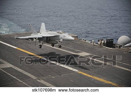 An F/A-18E Super Hornet lands aboard the aircraft carrier USS Nimitz. View Large Photo Image Picture - An F/A-18E Super Hornet lands aboard the aircraft carrier USS Nimitz.. Fotosearch