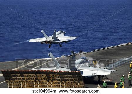 An F/A-18E Super Hornet launches from the aircraft carrier USS Ronald Reagan. View Large Photo Image Picture - An F/A-18E Super Hornet launches from the aircraft carrier USS Ronald Reagan.. Fotosearch