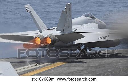 Picture - An F/A-18E Super Hornet launches from USS Nimitz.. Fotosearch