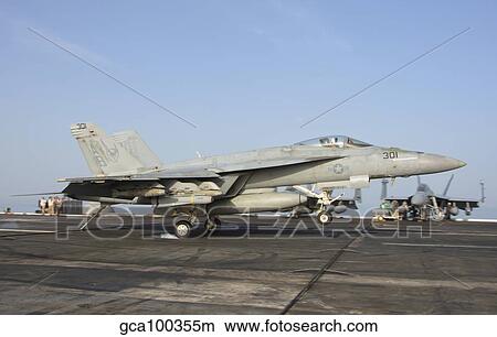 An F/A-18E Super Hornet makes an arrested landing aboard an aircraft carrier. View Large Photo Image Picture - An F/A-18E Super Hornet makes an arrested landing aboard an aircraft carrier.. Fotosearch